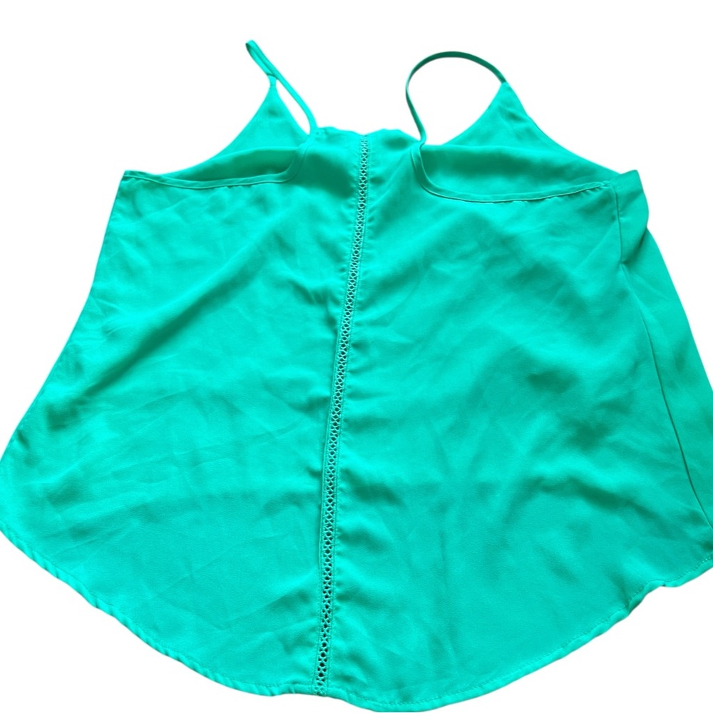 Ambiance Apparel green halter top with a flowy hem and adjustable straps. Size M